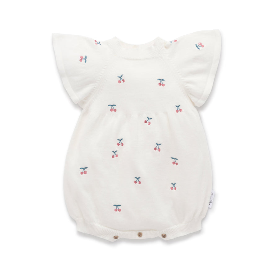 White knot baby romper with cherry print and flutter sleeves