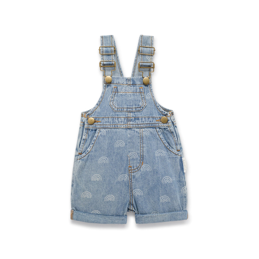 Light Denim coloured child overalls with rainbow print all over detail