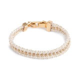 A&C Oslo Friendship Bracelet from the new for 2026 Sandy Beach Collection at Cerise.  This White and Gold bracelet features delicate 14K gold plated beads carefully braided with white cord to form a stunningly simple bt beautiful bracelet.  Features a 14k gold plate clasp and measures 17cm plus a 3cm extension.