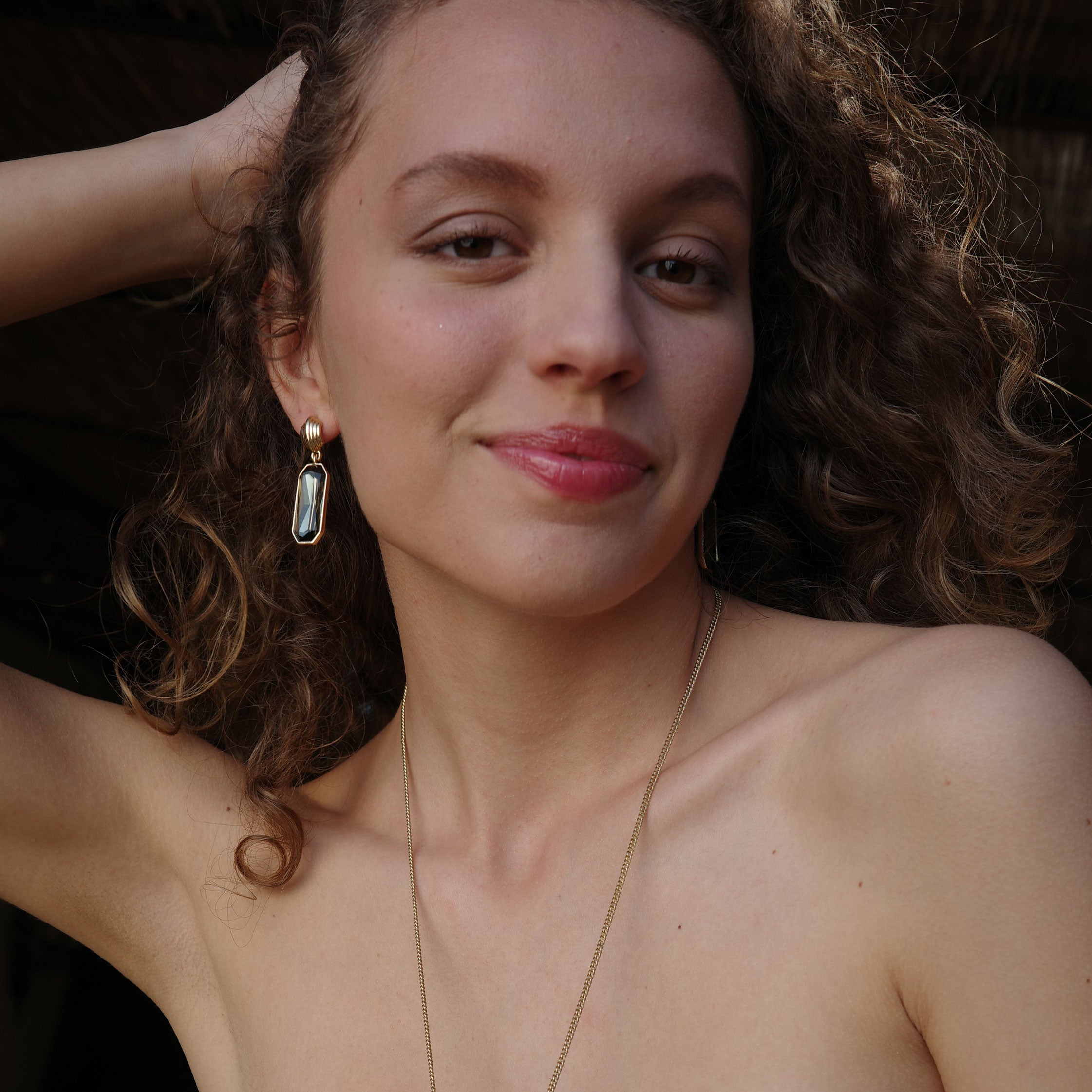 A&C Oslo Grace Collection Earrings , shown on a model featuring olive green coloured cut glass drops and 14Kgold plating.  These statement earrings are stunning at Cerise NZ
