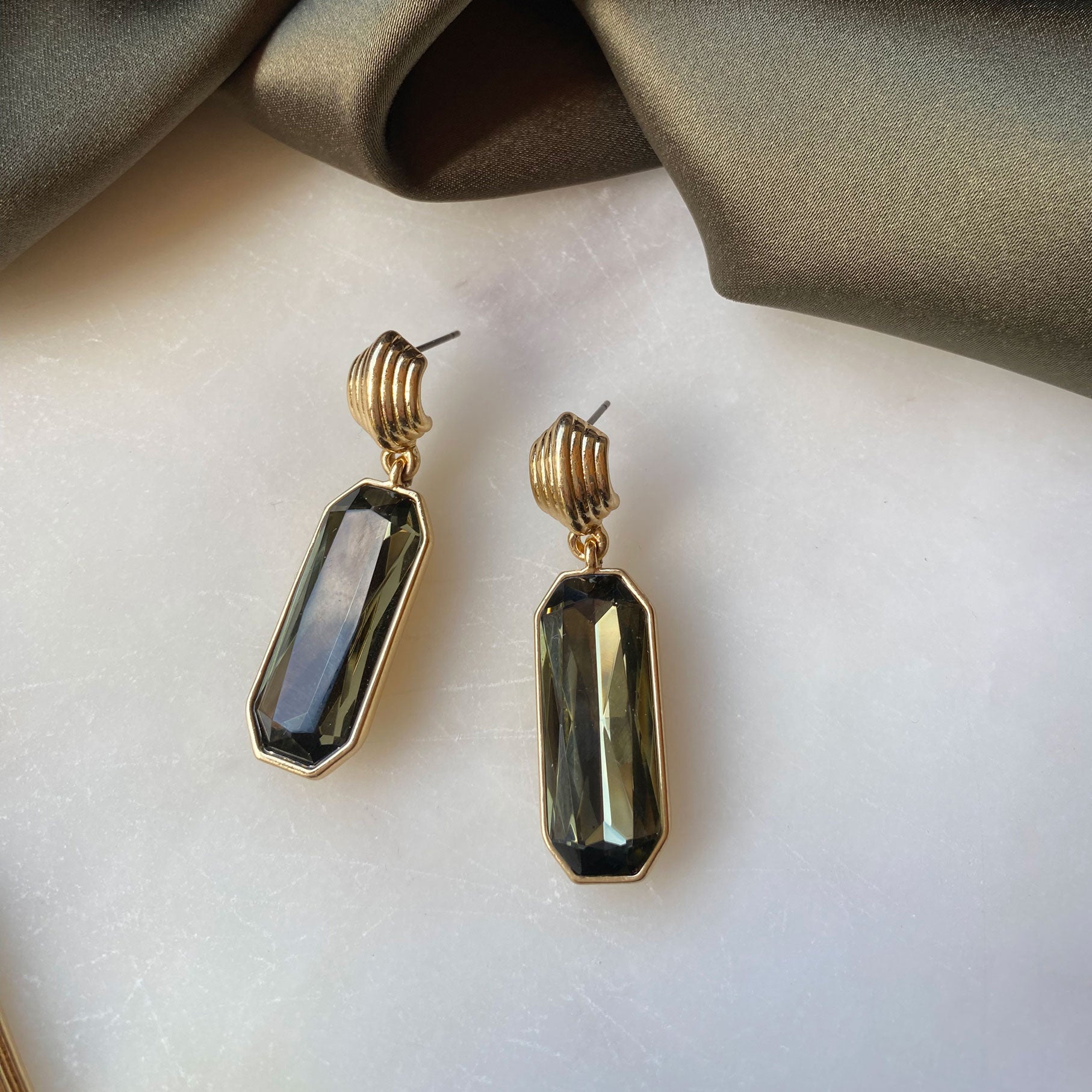 A&C Oslo Grace Collection Earrings featuring olive green coloured cut glass drops and 14Kgold plating.  These statement earrings are stunning at Cerise NZ