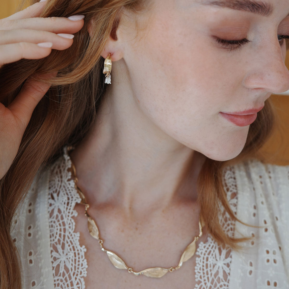 New from A&C Oslo this season, shown on a model are our stunning Lillies and Pearl Creol Earrings.  Finished 14K gold plate and featuring two delicate pearls and a lilly dropping from a stunning gold creol hoop. Earring drop measures 23mm at Cerise NZ.