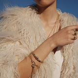 New at Cerise this season  the A&C Oslo Shimmer Collection features this gorgeous Gold Bracelet with tassels gently falling from a medium link chain.  Pictured here on a model showing how it can be matched with other bangles to create a layered look.
The Shimmer Collection is finished in 14K gold plate for stunning shine and durability.