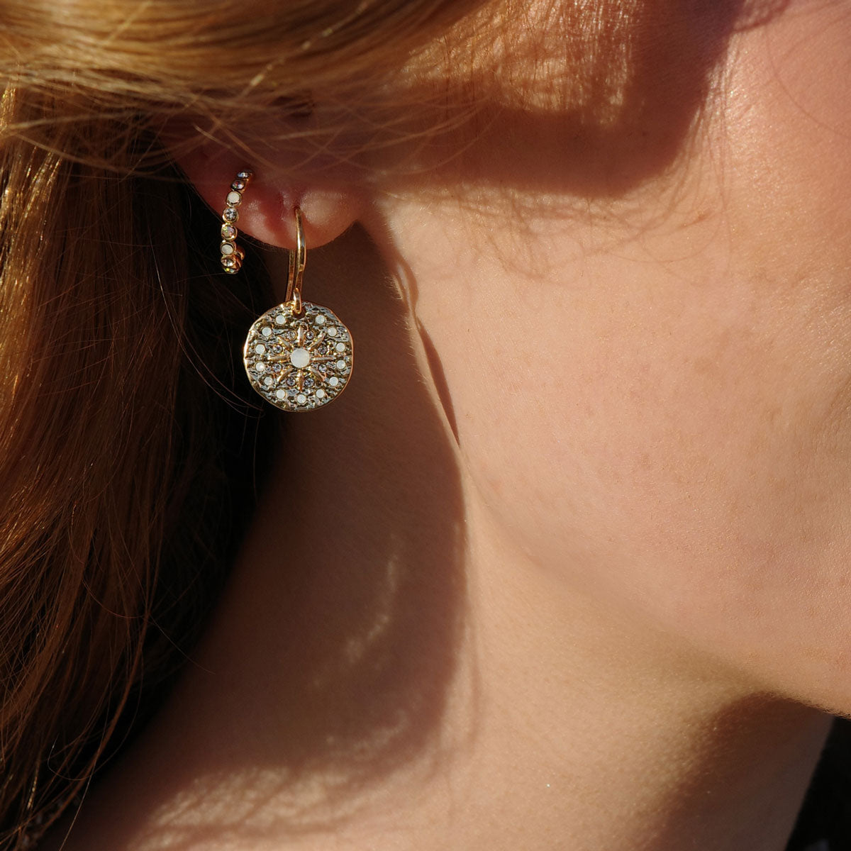 These stunning Solstice Gold Creole Earrings are paired with our solstice gold hook earrings to create this   new season look from the A&C  Oslo Shimmer collection.
The Shimmer Collection features white opal stones, crystals and bohemian details to bring out the beauty in the natural and imperfect. These pieces are great to match with feminine and bohemian fashion trends and are 14K Gold plated at Cerise.