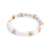 A&C Oslo Enamel Bracelet in White enamel with gold beads and white stones.  Stones have black veins running through them.  Measures 20cm at Cerise