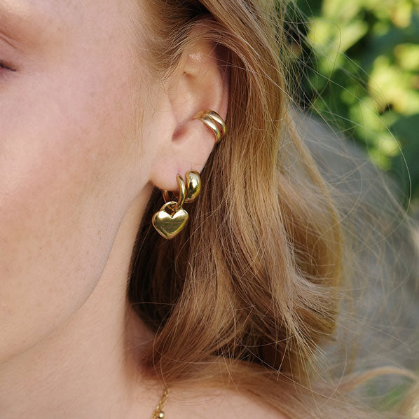 A&C Oslo earrings in 14K gold plate over steel.  They feature beautiful little hearts falling delicately from 14mm hoops.  Perfect for layering with other jewellery basics at Cerise NZ