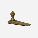 Aluminium door stopper finished in antique Brass colour.  Ideal door wedge and features the iconic acorn at Cerise