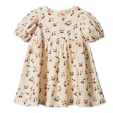 Children's dress with cherry pattern on a white background