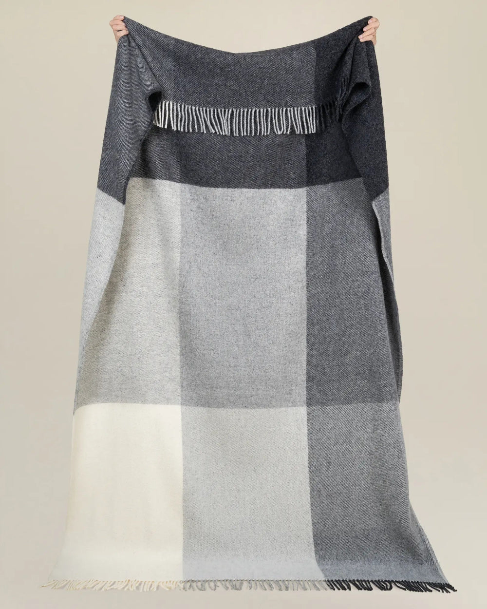 Weave Bayswater Charcoal Throw at Cerise.  Made in 100% New Zealand Wool in a check design in varying shades of charcoal.  Has fringed ends and throw measures 150cm x 240cm