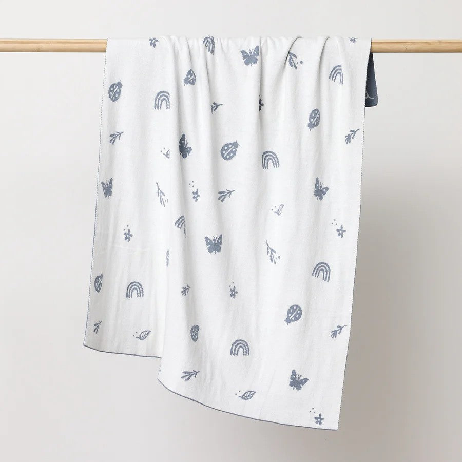 A beautiful and thoughtful newborn baby gift, this premium knitted baby blanket in Enchanted Garden Design, is designed to be treasured for years to come. Shown here is Sky colour which is fully reversible to white with sky coloured icons. Made from certified organic cotton, it is wonderfully soft, warm, and cosy, making it perfect for keeping little ones comfortable from day one.