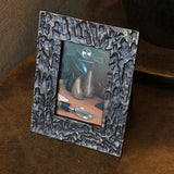 Concept picture of a Bronze coloured textured photo frame made from aluminium. Wide frame which takes a 4 x 6 inch photo at Cerise