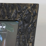 Close up view to show detail  of Bronze coloured textured photo frame made from aluminium. Wide frame which takes a 4 x 6 inch photo at Cerise