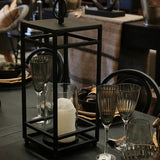 Concept photo of the Ludlow Hurricane Lantern finished in matt black coloured iron with a glass cylinder for your candle from Cerise.