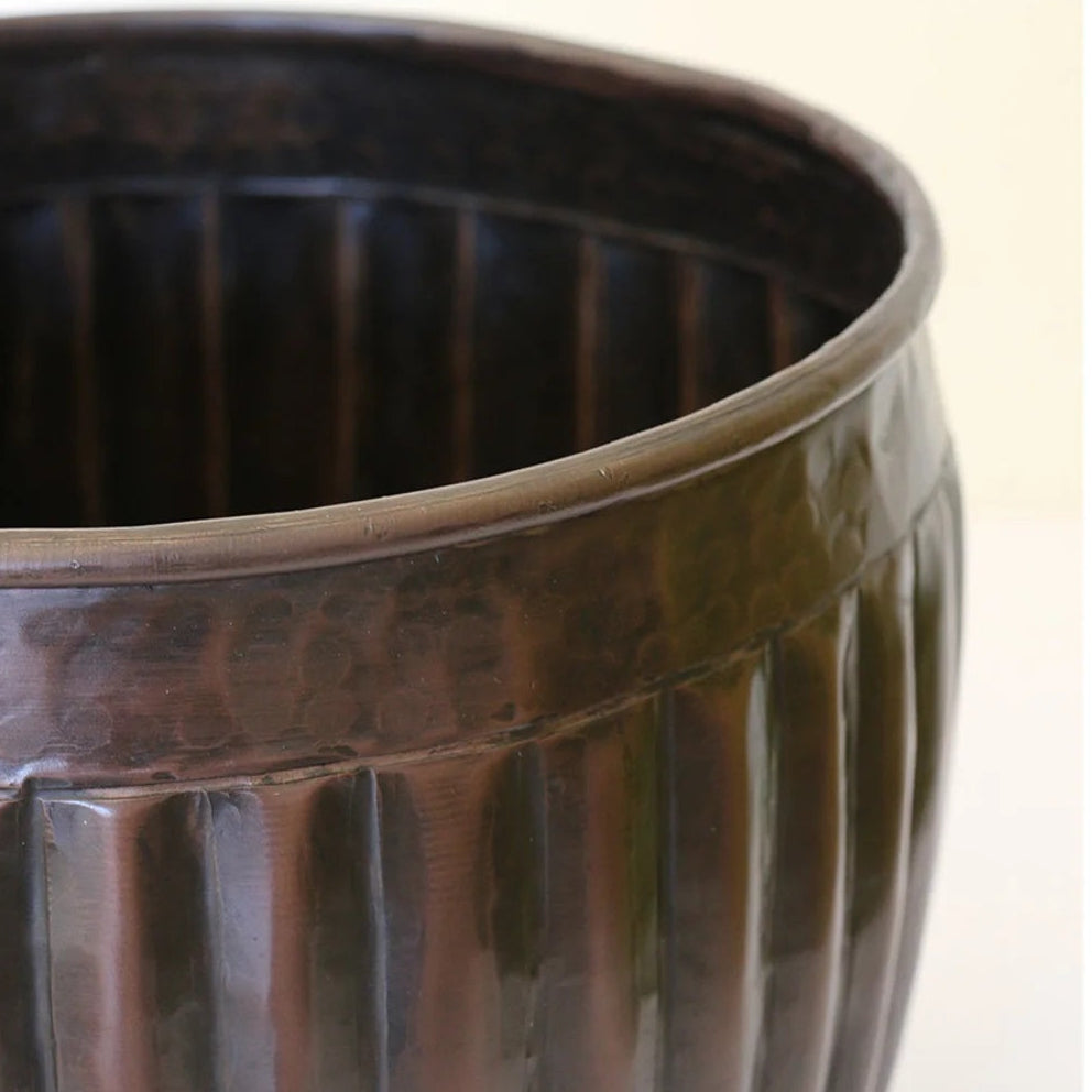 Detail of the CC Interiors Marbella Medium Planter at Cerise in Antique Black colour measures 280mm diameter by 240mm high. Made from aluminium for indoor plant display.