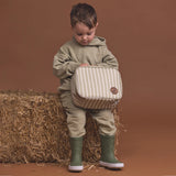 A child holding a Crywolf Everyday Lunchbag to keep kids snacks cool and luches fresh at Cerise. Made with food grade insulated lining and removeable non-toxic gel pad to keep food cool and has a handy carry handle. Available in Green Elm Stripe Design for boys and girls.