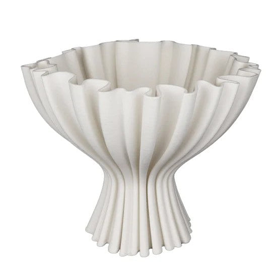 White ceramic bowl with a textured, scalloped edge on a white background