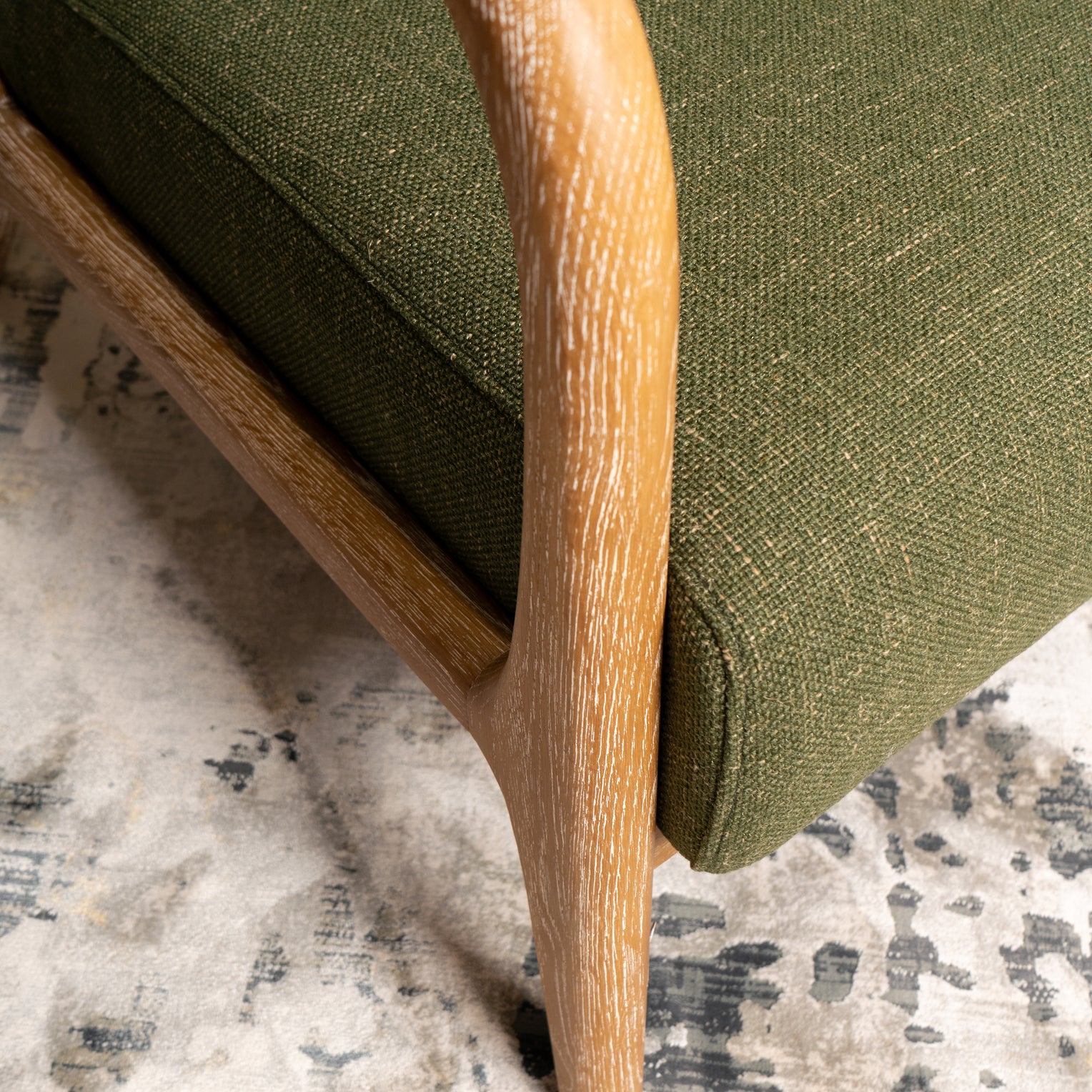 Luca occasional chair - close up photo showing Juniper Green upholstery and washed oak arms