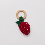 Over the andelions Crochet Strawberry Rattle at Cerise. Made from 100% crochet cotton outer, polyester filling and beechwood teething ring. 