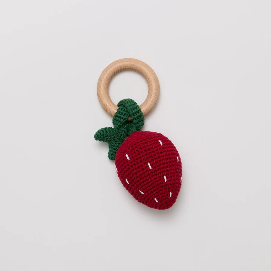 Over the andelions Crochet Strawberry Rattle at Cerise. Made from 100% crochet cotton outer, polyester filling and beechwood teething ring. 