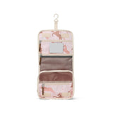  The Crywolf Hanging Toiletry Bag in Blushing Ponies design at Cerise. Makes the perfect travel companion. Made to keep all their bathroom essentials organised on the go, it features a removable mirror, zippered internal mesh pockets, multiple compartments, and a convenient hanging hook. Made from durable, water-resistant fabric 