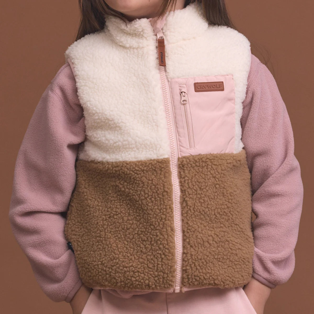 Crywolf reversible Yeti Vest in Harvest soft pink colour at Cerise. Reverses from colour block pattern on sherpa fleece side to soft pink on recycled polyester puffer side.