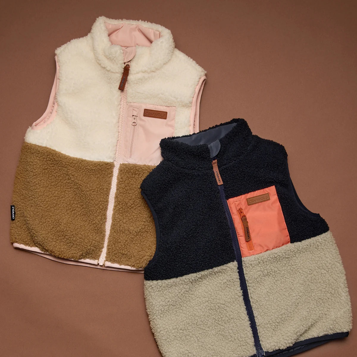 Crywolf reversible Yeti Vest in Harvest soft pink colour and Ash design in blue and natural colourbolock at Cerise. Reverses from colour block pattern on sherpa fleece side to soft pink on recycled polyester puffer side.