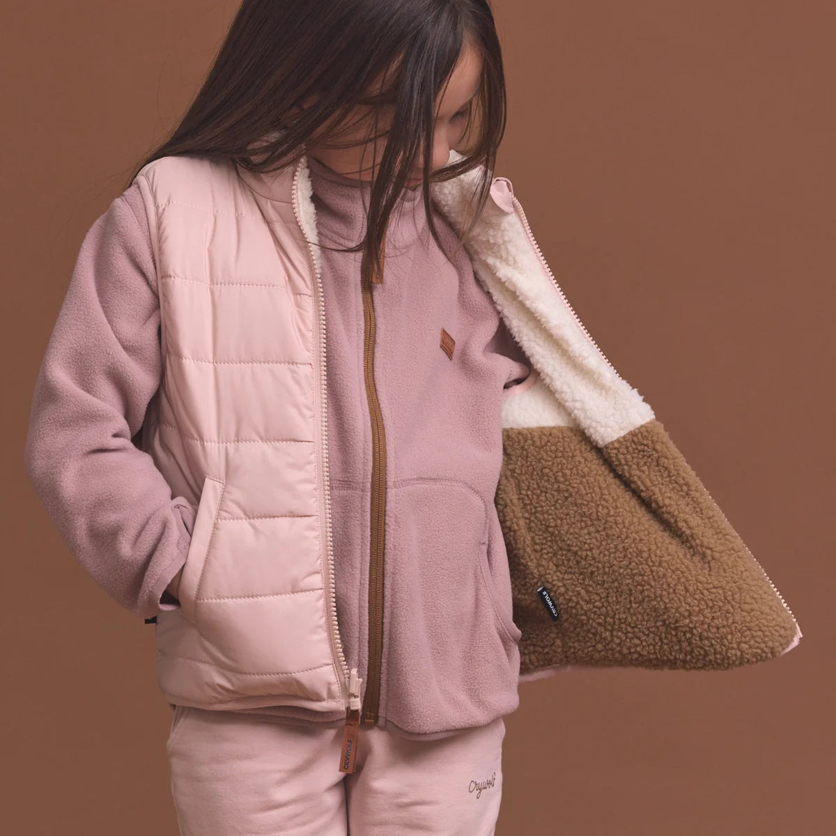 Crywolf reversible Yeti Vest in Harvest soft pink colour at Cerise. Reverses from colour block pattern on sherpa fleece side to soft pink on recycled polyester puffer side.
