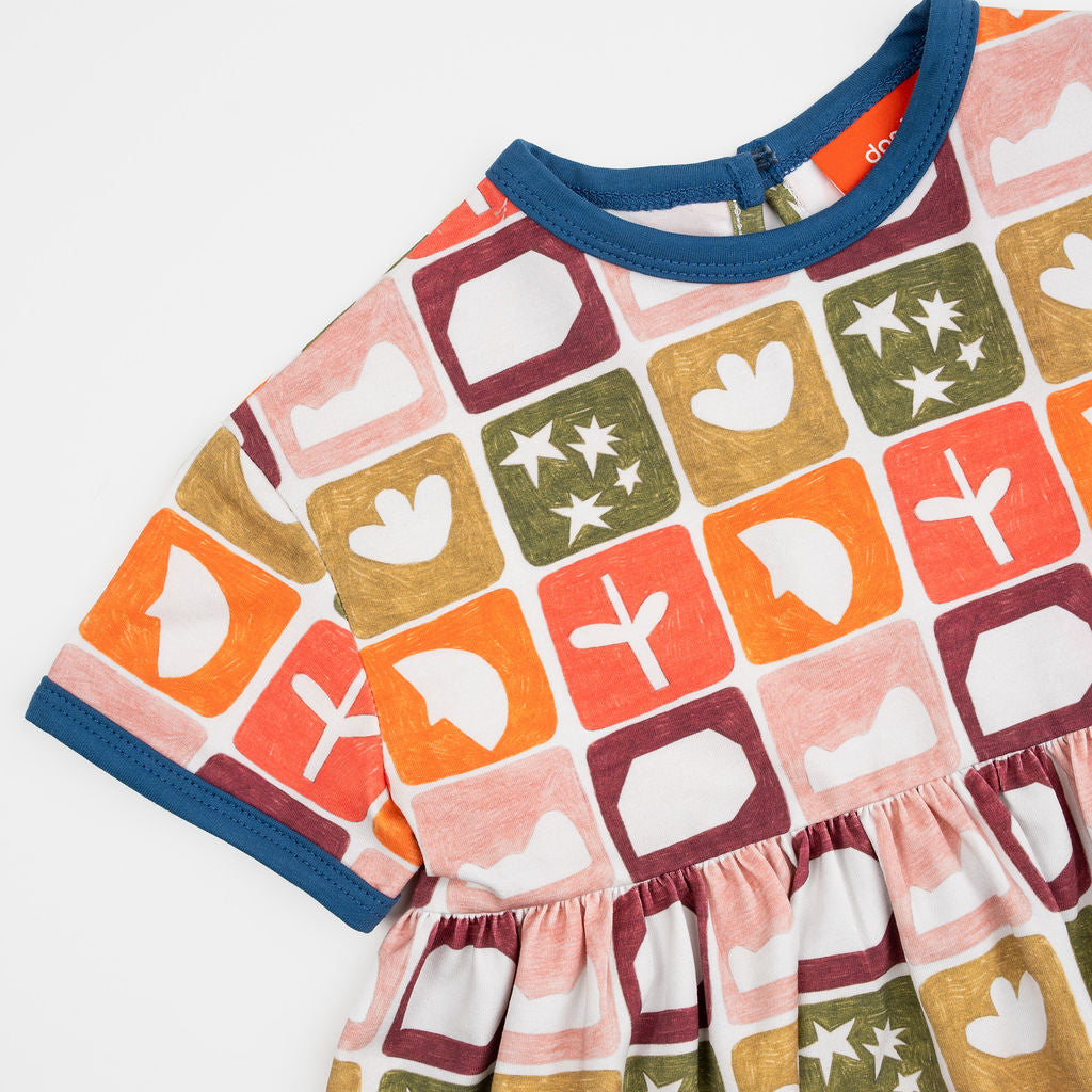 Das Ist Maurice Empire Dress in Midnight Memory print at Cerise. Featuring an exclusive geometric print inspired by treasured moments and nostalgic patterns, the Midnight Memory Dress brings a distinctive, artistic feel to a classic kids’ silhouette. The empire waist creates a relaxed, flowing shape, while the gathered skirt adds movement and plenty of room for little ones to twirl, play and explore.