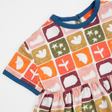 Das Ist Maurice Empire Dress in Midnight Memory print at Cerise. Featuring an exclusive geometric print inspired by treasured moments and nostalgic patterns, the Midnight Memory Dress brings a distinctive, artistic feel to a classic kids’ silhouette. The empire waist creates a relaxed, flowing shape, while the gathered skirt adds movement and plenty of room for little ones to twirl, play and explore.