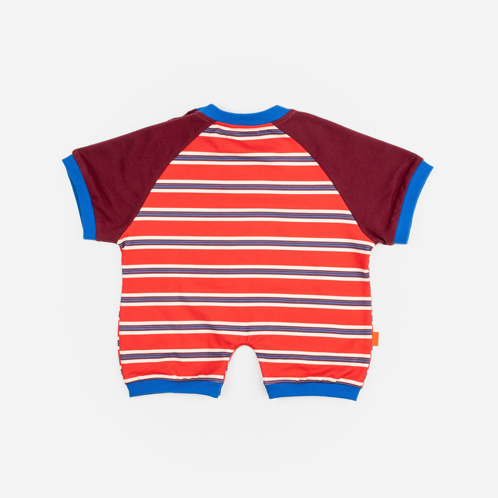 Das Ist Maurice Romper in sunset design featuring bright red and blue striped body with contrast burgundy sleeves bound in a bright blue.  A sporty look for babies and toddlers at Cerise.