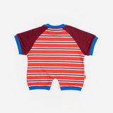 Das Ist Maurice Romper in sunset design featuring bright red and blue striped body with contrast burgundy sleeves bound in a bright blue.  A sporty look for babies and toddlers at Cerise.