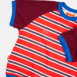 Das Ist Maurice Romper in sunset design featuring bright red and blue striped body with contrast burgundy sleeves bound in a bright blue.  A sporty look for babies and toddlers at Cerise.