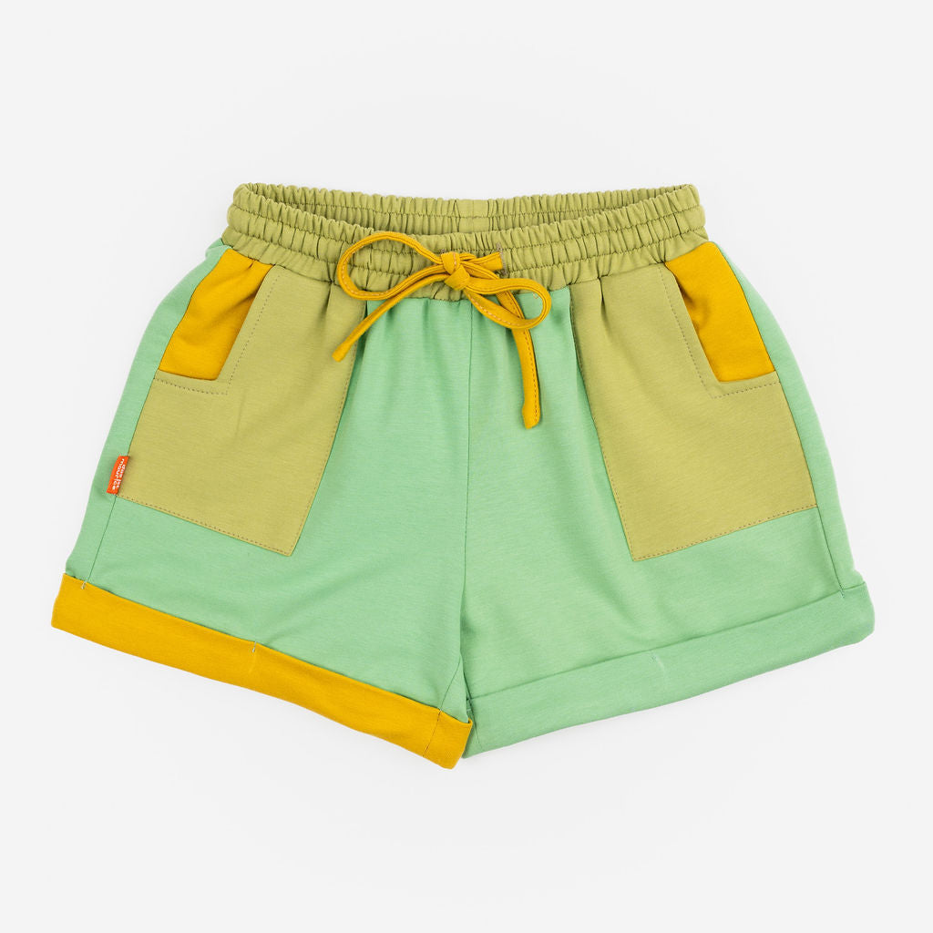 Das Ist Maurice Shorts in Meadow at Cerise. Made from 100% cotton in soft green with  Contrasting pockets, mustard yellow drawstring and rolled cuffs .