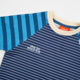 Das Ist Maurice Tshirtin Seabreeze Stripe at Cerise.  Contrasting blue and navy vertical stripes on the raglan sleeves create a fun mix of patterns and colour, giving this striped kids’ T-shirt a distinctive Das Ist Maurice finish. The combination of classic stripes and playful colour blocking makes it an easy piece to style with kids’ shorts, pants or jeans.