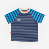 Das Ist Maurice Tshirtin Seabreeze Stripe at Cerise.  Contrasting blue and navy vertical stripes on the raglan sleeves create a fun mix of patterns and colour, giving this striped kids’ T-shirt a distinctive Das Ist Maurice finish. The combination of classic stripes and playful colour blocking makes it an easy piece to style with kids’ shorts, pants or jeans.