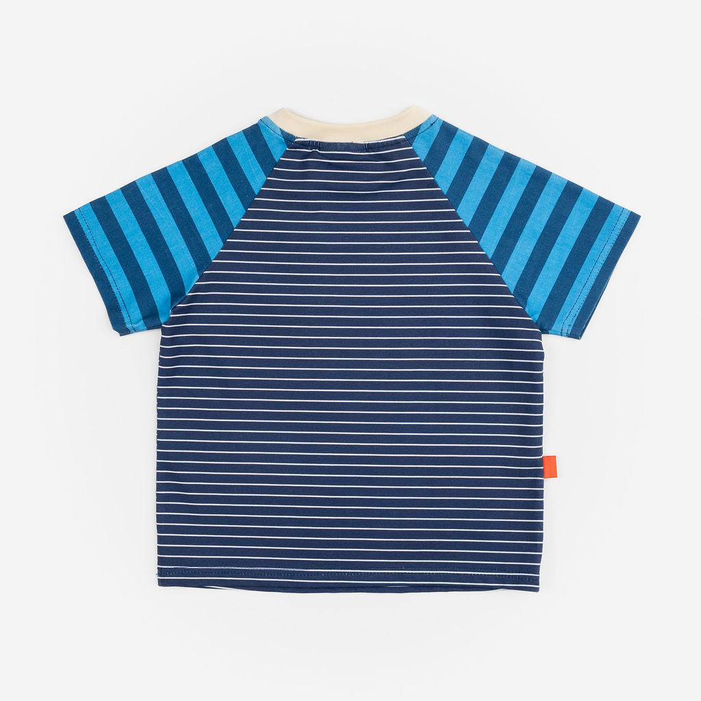 Das Ist Maurice Tshirtin Seabreeze Stripe at Cerise.  Contrasting blue and navy vertical stripes on the raglan sleeves create a fun mix of patterns and colour, giving this striped kids’ T-shirt a distinctive Das Ist Maurice finish. The combination of classic stripes and playful colour blocking makes it an easy piece to style with kids’ shorts, pants or jeans.