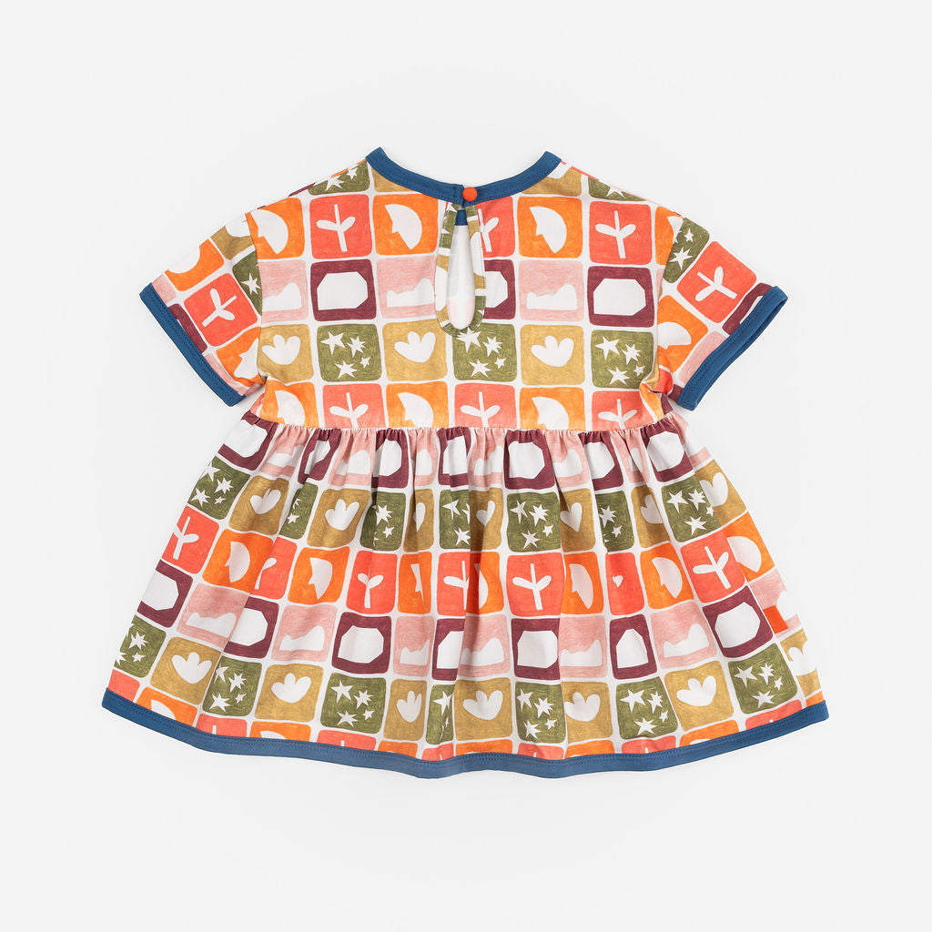 Das Ist Maurice Empire Dress in Midnight Memory print at Cerise. Featuring an exclusive geometric print inspired by treasured moments and nostalgic patterns, the Midnight Memory Dress brings a distinctive, artistic feel to a classic kids’ silhouette. The empire waist creates a relaxed, flowing shape, while the gathered skirt adds movement and plenty of room for little ones to twirl, play and explore.