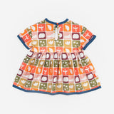 Das Ist Maurice Empire Dress in Midnight Memory print at Cerise. Featuring an exclusive geometric print inspired by treasured moments and nostalgic patterns, the Midnight Memory Dress brings a distinctive, artistic feel to a classic kids’ silhouette. The empire waist creates a relaxed, flowing shape, while the gathered skirt adds movement and plenty of room for little ones to twirl, play and explore.