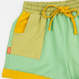 Das Ist Maurice Shorts in Meadow at Cerise. Made from 100% cotton in soft green with  Contrasting pockets, mustard yellow drawstring and rolled cuffs .