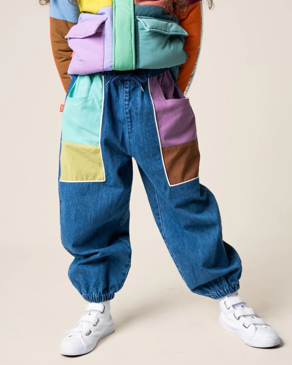 Das Ist Maurice Denim Barrel pants with colour blocked  green, yellow, purple and brown pockets. Feature an elastic waist with drawstring and elastic cuffs at Cerise