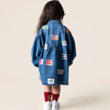 Das Ist Maurice Denim Smock Dress with long sleeves, front patch pockets, button front, collar and gathered yoke at the front with a V shaped gathered yoke at the back. Has a patchwork stamp pattern on the fabric at Cerise NZ