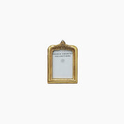 Gold coloured photo frame with floral detail