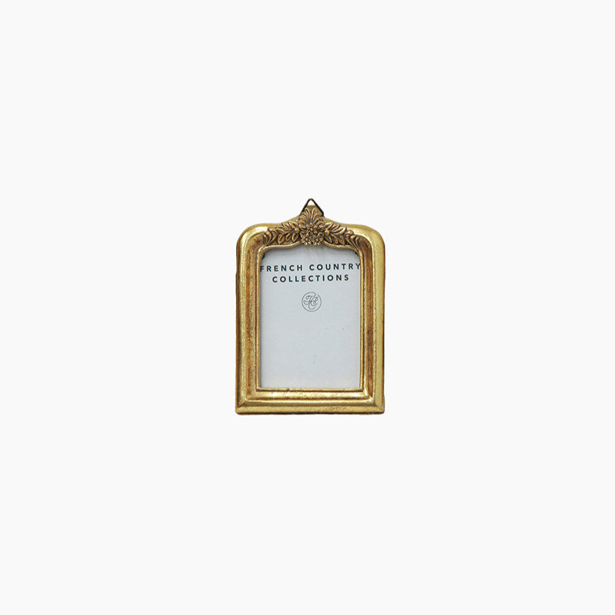 Gold coloured photo frame with floral detail