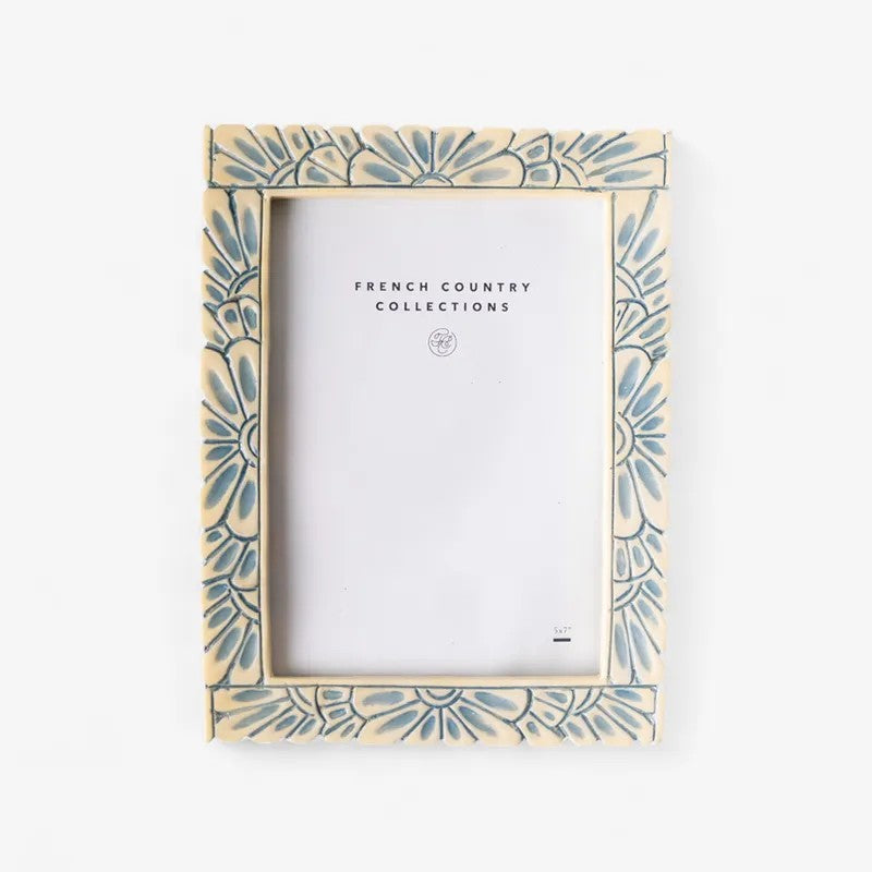 Decorative picture frame with blue  floral pattern on an off white background