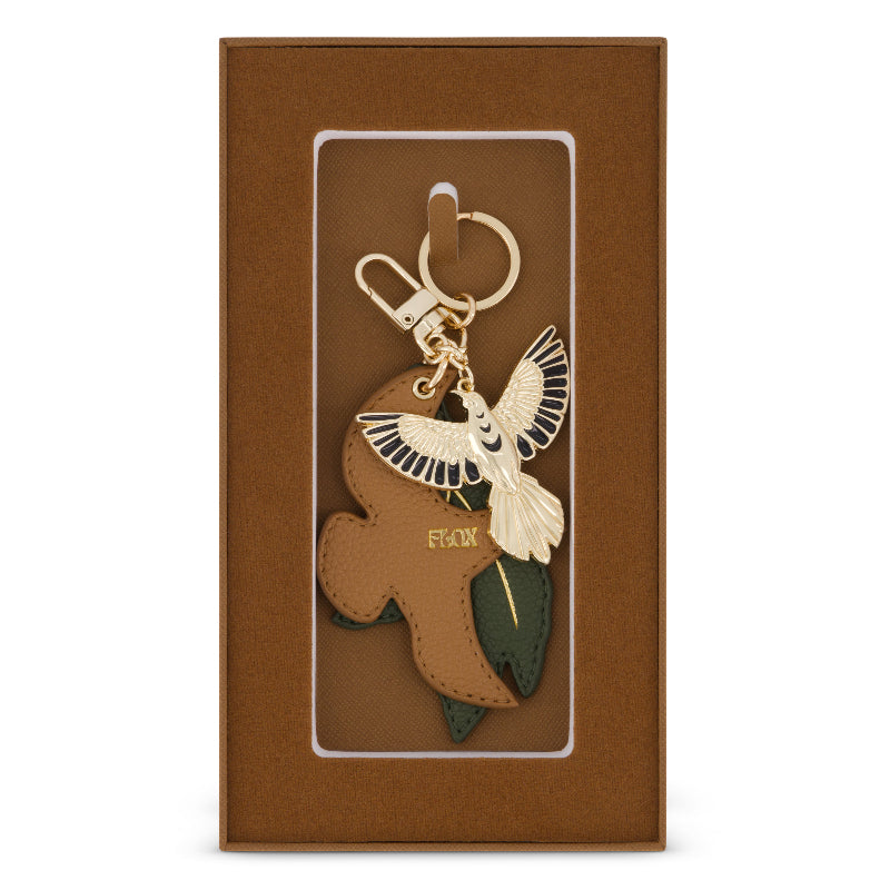 Flox Keycharm featuring a gold coloured metal tui and vegan leather tui and leaf in gift box
