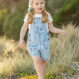 Light blue denim overalls with frayed edge decorative floral patches
