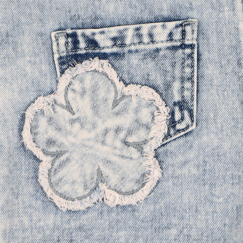 Light blue denim overalls with frayed edge decorative floral patches