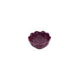 Purple ceramic bowl with scalloped edge on a white background