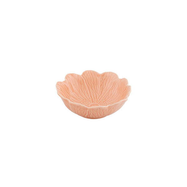 Pink ceramic bowl with scalloped edge on a white background