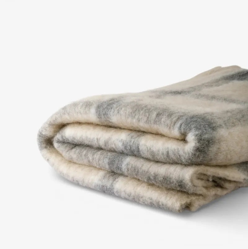 Juniper Throw from French Country Collections at Cerise. Featuring Grey Check stripes on a neutral background.